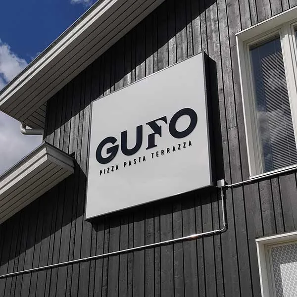 Gufo Pizza Pasta Terrazza sign on the exterior wall of a dark building