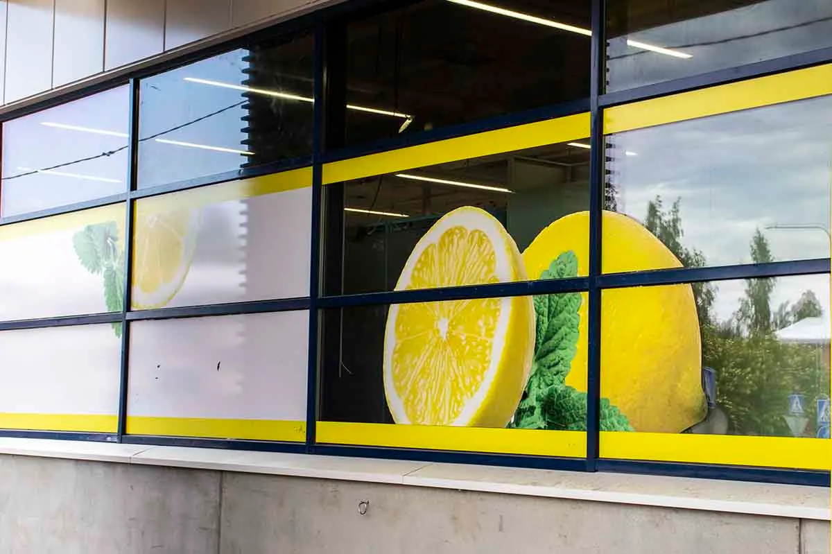 Large lemons and mint leaves in shop window graphics between yellow bands