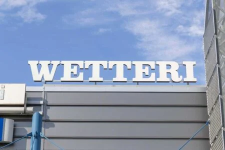 Large white Wetteri letters on a building roof against a blue sky Large white Wetteri letters on a building roof against a blue sky