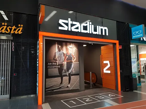 White Stadium logo above a black and orange entrance portal