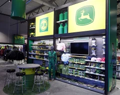 A store display wall with John Deere logos, clothing, caps and other products. A store display wall with John Deere logos, clothing, caps and other products.