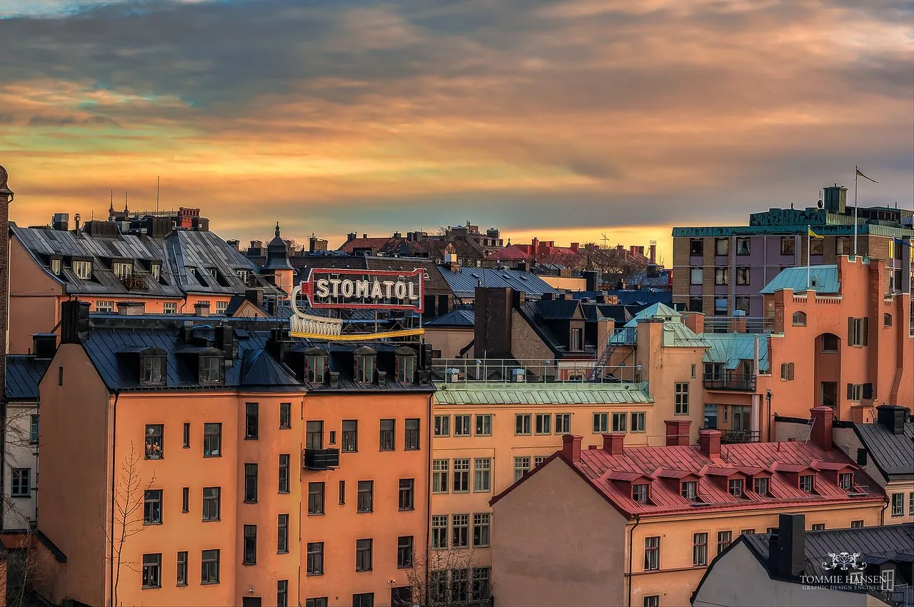 Stomatol sign above rooftops in Slussen, Stockholm, at sunset