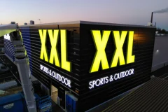 Yellow XXL letters and white Sports & Outdoor text on two sides of a building.