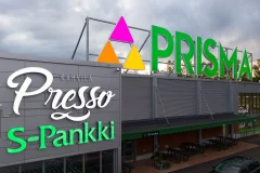 Large Prisma, Presso and S-Pankki signs on a commercial building facade.