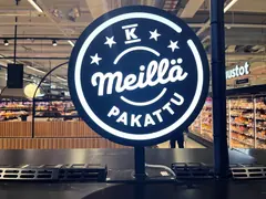 Round illuminated Meillä pakattu sign with the K symbol at KSM Löytis Round illuminated Meillä pakattu sign with the K symbol at KSM Löytis