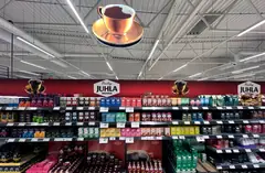 Hanging coffee cup decoration and red backdrop above coffee shelves in a grocery store Hanging coffee cup decoration and red backdrop above coffee shelves in a grocery store