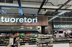 Illuminated Tuoretori and Kotikeittiö signs above grocery store departments Illuminated Tuoretori and Kotikeittiö signs above grocery store departments